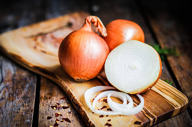 golden onions on rustic wooden background